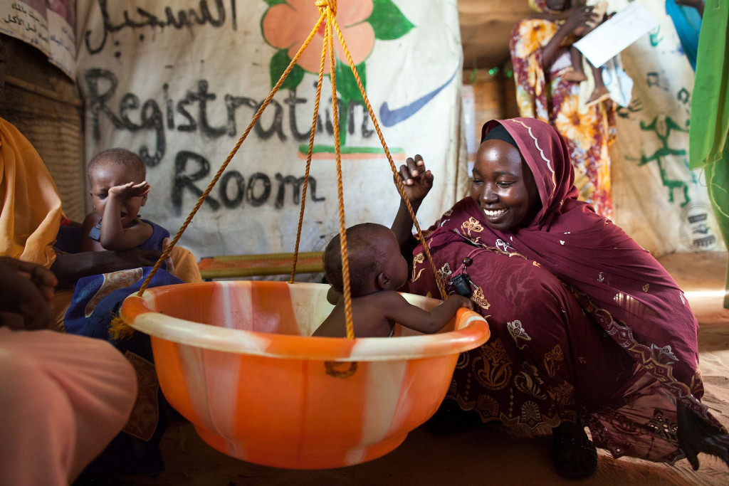 A woman weights her child with malnutrition in a clinic in North Darfur. Photo: Albert González Farran, UNAMID
